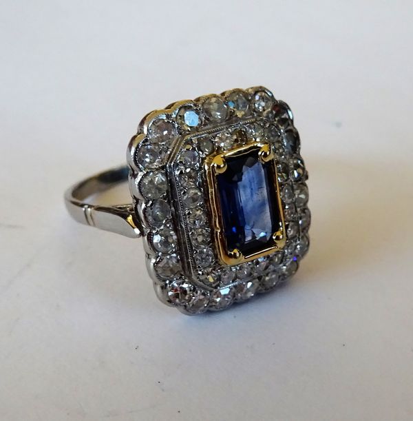 A diamond and sapphire set rectangular cluster ring, mounted with the rectangular step cut sapphire at the centre, in a two row surround, mounted with