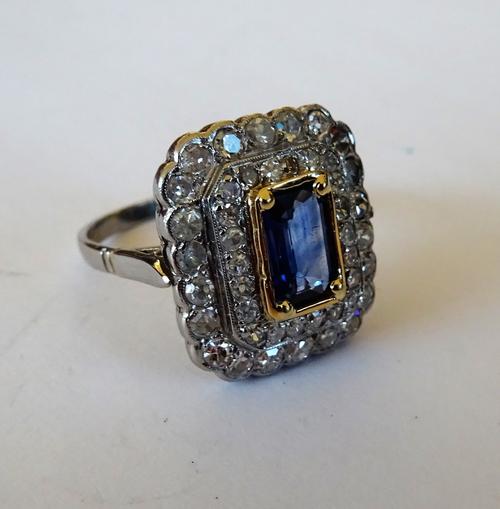 A diamond and sapphire set rectangular cluster ring, mounted with the rectangular step cut sapphire at the centre, in a two row surround, mounted with