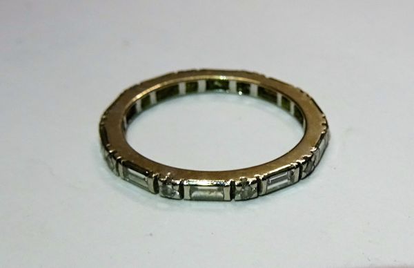 A platinum and diamond set full eternity ring, mounted with alternating baguette and circular cut diamonds, ring size N.