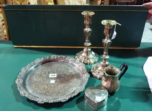 A group of plated wares, comprising;  a shaped circular salver, decorated with a border of fruiting vine, diameter 31cm, a pair of table candlesticks,