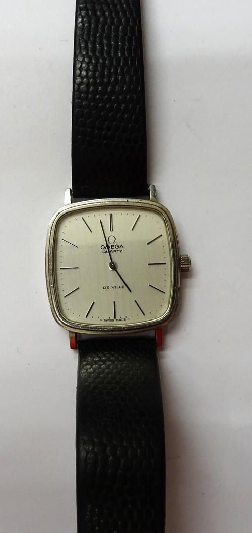 An Omega De Ville Quartz curved square cased gentleman's wristwatch, the signed brushed silvered dial with baton shaped numerals, fitted with a black