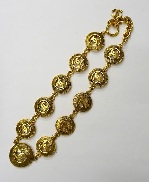 A Chanel gilt metal collar necklace, formed as a series of circular links, each pierced with the intertwined CC logo to the centre within a textured s