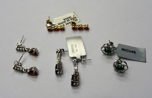 A pair of gold and red gem set three stone earrings, detailed 10 K, the backs with post and butterfly clip fittings, a pair of silver and cabochon eme