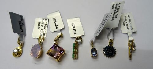 A 9ct gold and diamond single stone pendant, claw set with a circular cut diamond, in a drop shaped design, a 9ct gold and diamond pendant in a comet