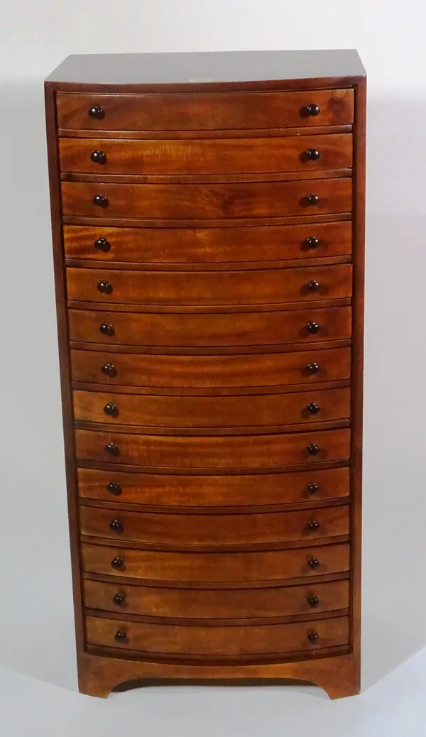 A Victorian style hardwood bowfront collectors chest with fourteen drawers on bracket feet, 43cm wide x 94cm high x 31cm deep.