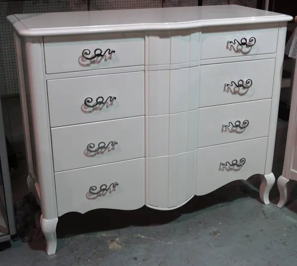 A serpentine white lacquer chest of four long drawers on cabriole supports, 126cm wide x 100cm high.