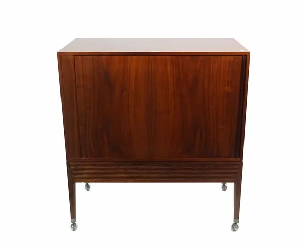 A mid-20th century teak side cabinet with tambour front on tapering supports, 83cm wide x 89cm high.