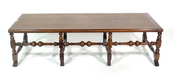 A 17th century style oak rectangular footstool on turned supports, 152cm wide x 43cm high.