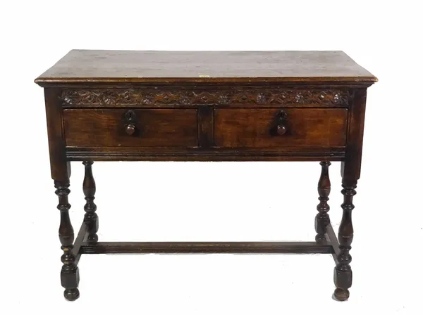 An 18th century style oak two drawer side table, 106cm wide x 81cm high.