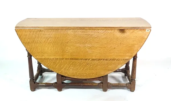 An 18th century and later oak gate leg dining table, 135cm wide x 75cm high.