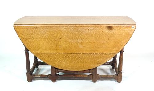 An 18th century and later oak gate leg dining table, 135cm wide x 75cm high.