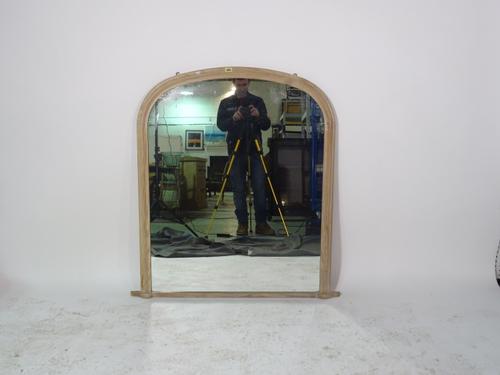 A 20th century pine arch top overmantel wall mirror, 90cm wide x 110cm high.
