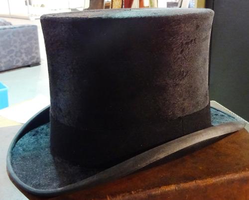 Herbert Johnson, 38 New Bond Street, London; a silk top hat in a brown leather case.