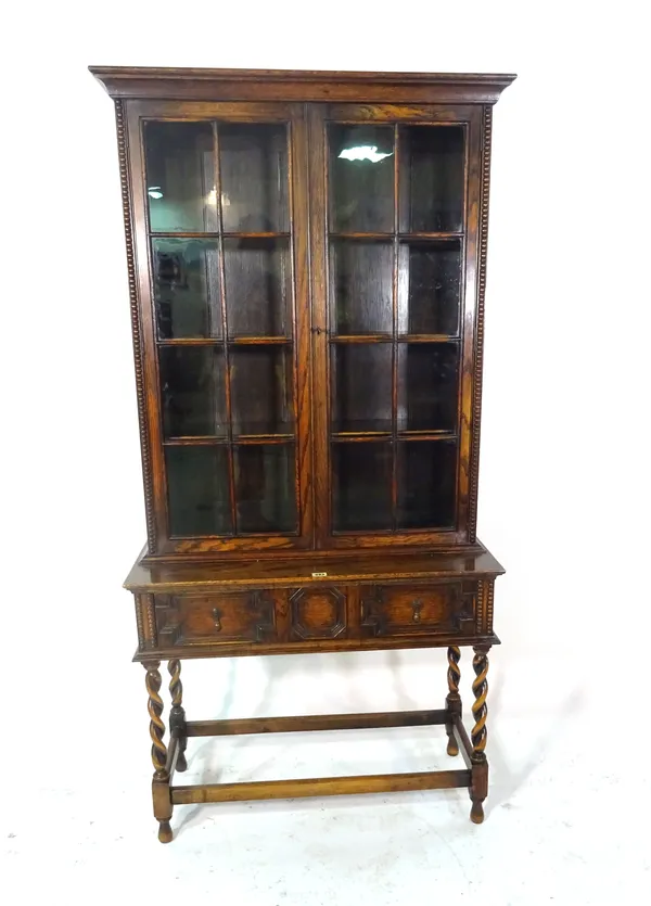 An 18th century style oak display cabinet with three geometric moulded drawers, 84cm wide x 167cm high.