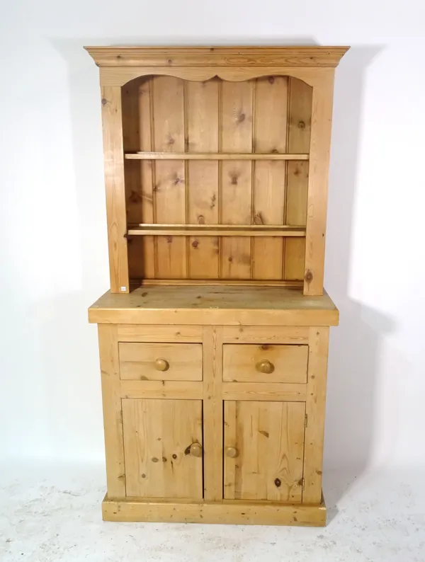 A 20th century pine dresser with a two tier plate rack, 92cm wide x 91cm high.