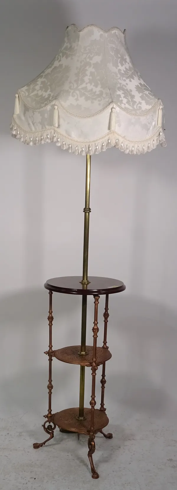 A mahogany brass and coppered standard lamp/ three tier occasional table.