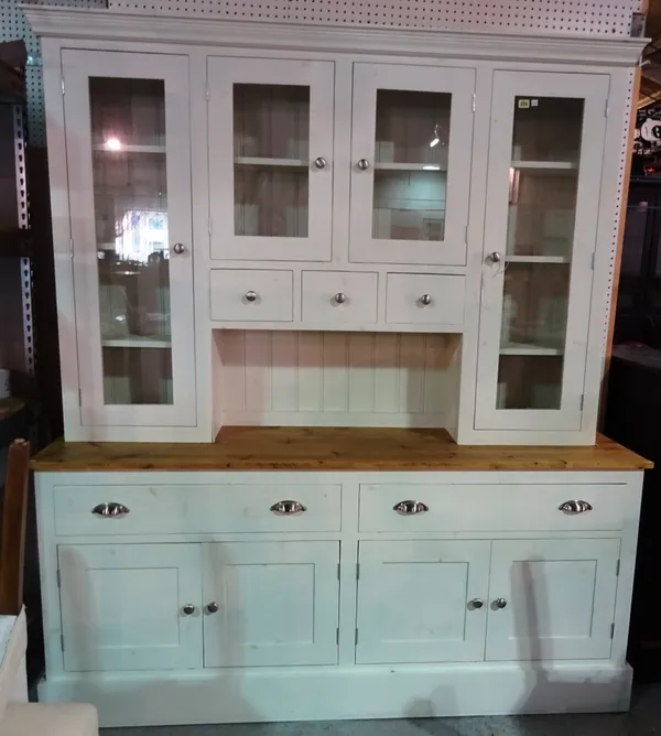 A 20th century painted pine dresser with glazed Delft rack over a pair of drawers and cupboards, 176cm wide x 203cm high.