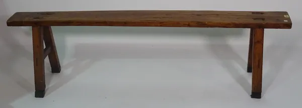 A 19th century fruitwood trestle ended bench, 161cm wide x 45cm high.