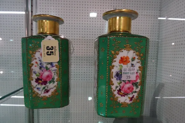 A pair of French green ground porcelain scent bottles, mid-19th of canted square section, each side painted with a panel of flowers inside gilt frames