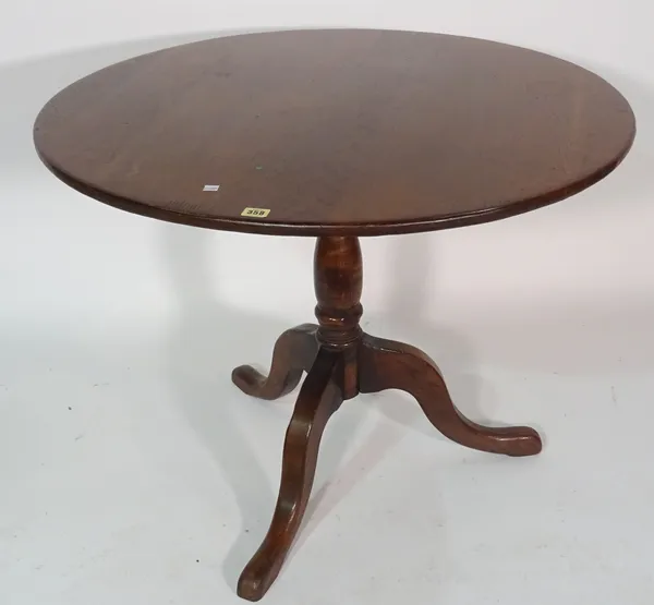 A 19th century oak tripod table on downswept supports, 90cm wide x 76cm high.