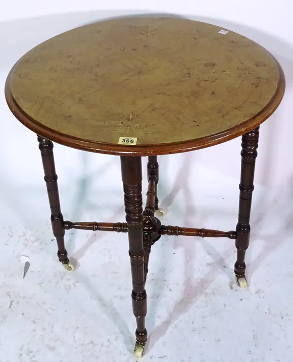 An Edwardian walnut circular side table on ring turned supports, 58cm wide x 63cm high.