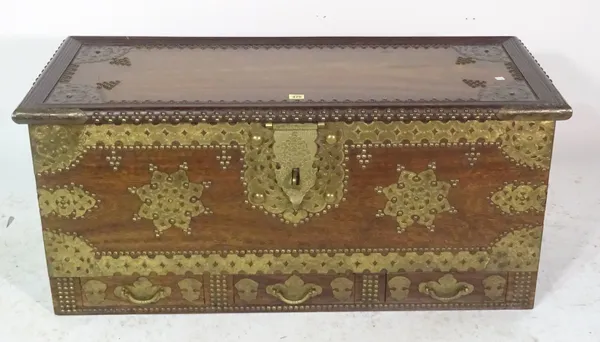 A 20th century African hardwood and brass bound studded trunk with three drawers, 111cm wide x 51cm high.