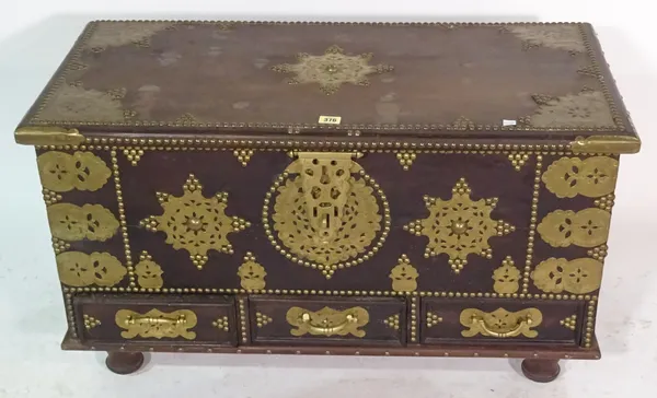 A 20th century African hardwood and brass studded trunk 90cm wide x 52cm high with three drawers.