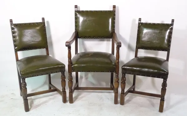 A pair of 20th century oak framed carved chairs with studded green leather upholstery together with two matching chairs (4).