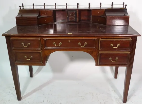 A Regency style mahogany desk on tapering supports, 122cm wide x 97cm high.
