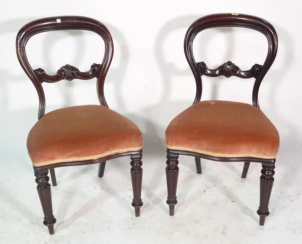 A pair of Victorian mahogany balloon back dining chairs on reeded tapering supports, (2).