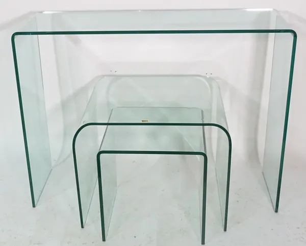 A nest of three glass side tables, the largest 100cm wide x 75cm high.