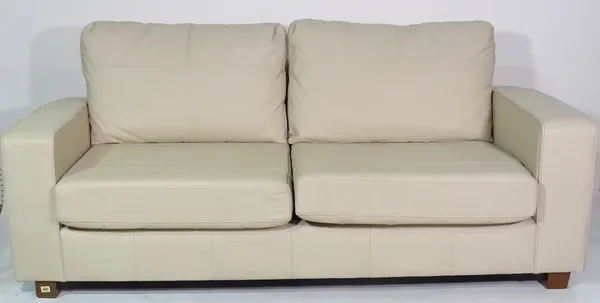 A 20th century faux white leather two seater sofa on block supports, 194cm wide.