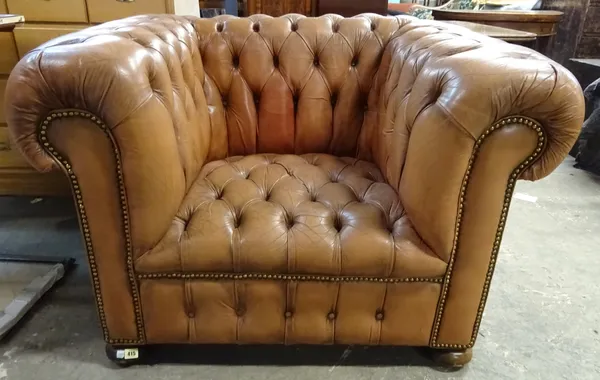 A 20th century brown leather Chesterfield type armchair, 110cm wide x 75cm high.