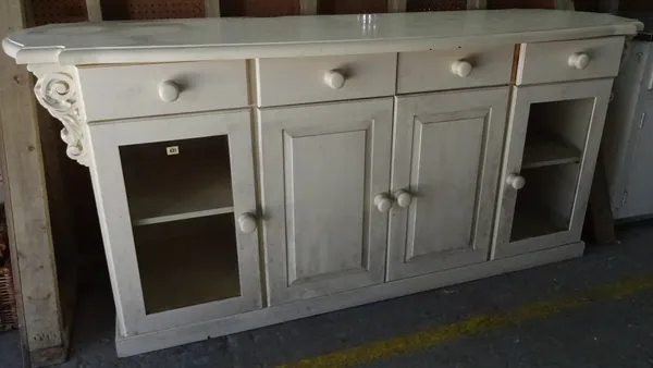 A 20th century white painted sideboard with four drawers over cupboard base, with acanthus moulded decoration, 210cm wide x 98cm high.