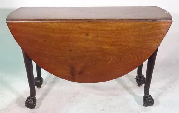A Victorian mahogany drop flap dining table on ball and claw supports.