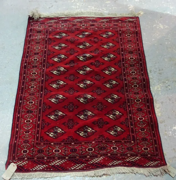 A Turkman rug, three columns of eight guls, 147cm x 107cm.