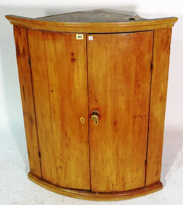A mid-18th century fruitwood bowfront hanging corner cupboard, 81cm wide x 100cm high.