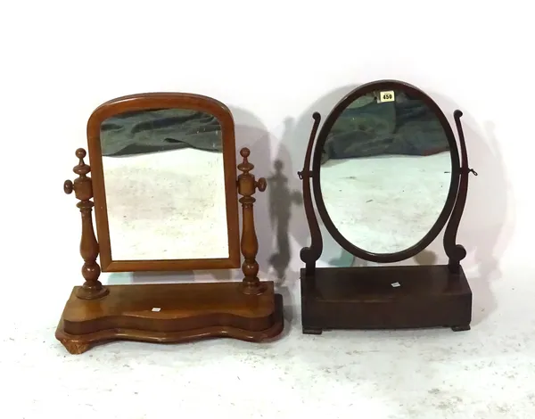 A George III mahogany bowfront toilet mirror, 41cm wide x 60cm high and a serpentine dressing table, 54cm wide x 60cm high, (2).