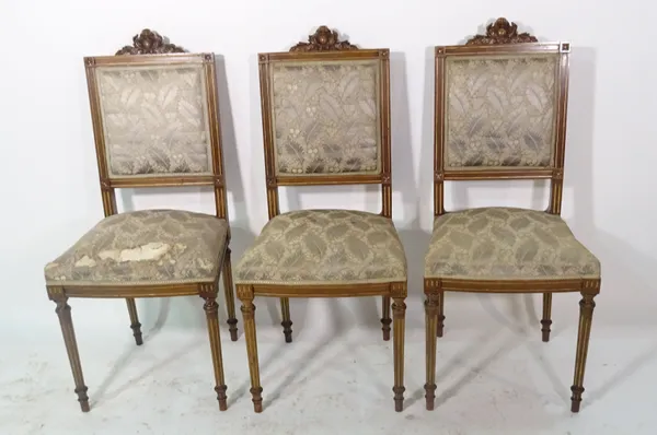A set of three French beech parcel gilt side chairs on fluted tapering supports (3).