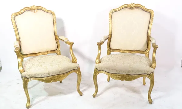 A pair of Louis XV style gilt open armchairs (2).