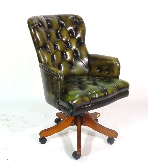 A 20th century mahogany framed office armchair with green leather button back upholstery.