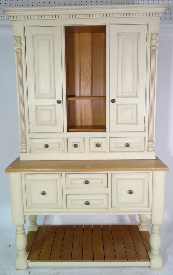 A 20th century cream painted kitchen dresser with cupboard doors over four short drawers, 128cm wide x 216cm high.