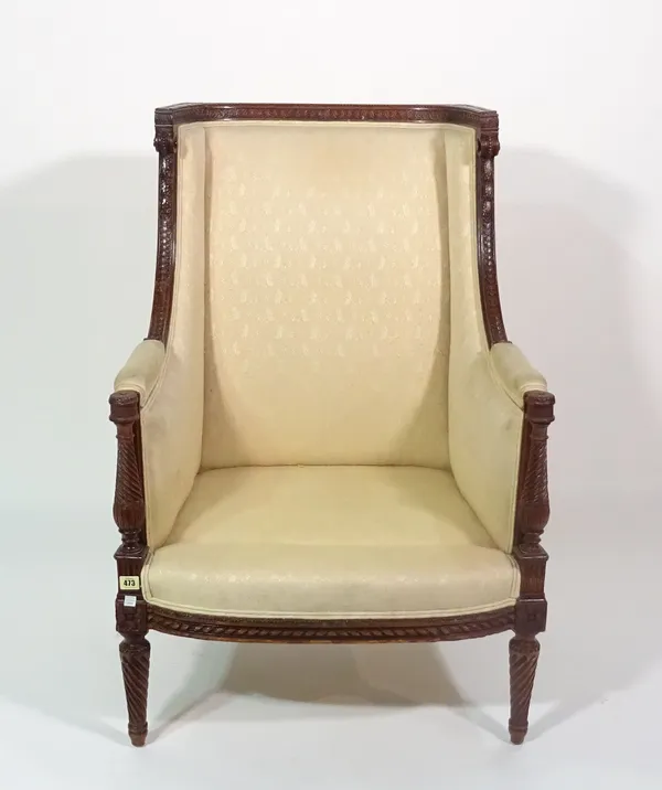 A Louis XVI style extensively carved mahogany square back armchair on spiral fluted supports, 71cm wide x 101cm high.