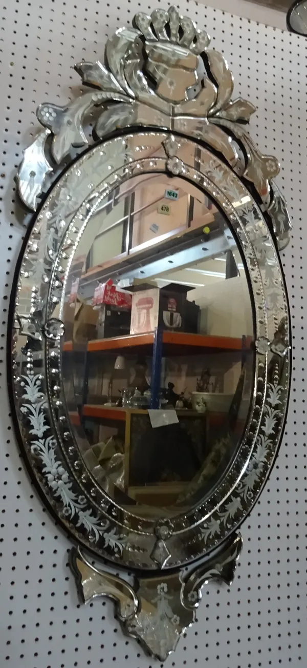 A 20th century cut and etched glass Venetian wall mirror, with bevelled oval plate, 67cm wide x 140cm high.