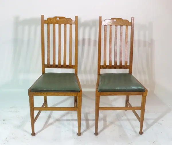 Shoolbred; a pair of late 19th century oak slat back chairs, on turned supports, 46cm wide x 103cm high (2).