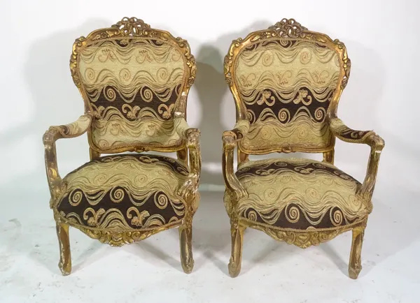 A pair of 19th century gilt framed open armchairs, on scroll supports, 64cm wide x 106cm high (2).