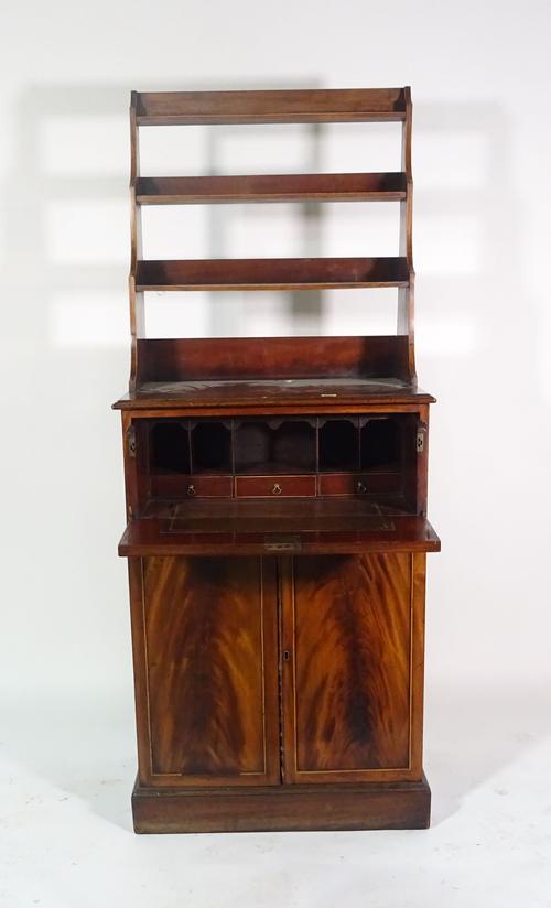 A George III mahogany secretaire waterfall bookcase, the open three tier back over fitted drawer and a pair of cupboards, 68cm wide x 167cm high x 43c