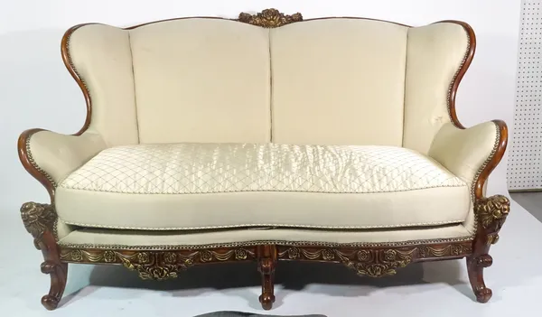A 20th century parcel gilt hardwood framed shaped sofa on scroll supports, 182cm wide x 107cm high.