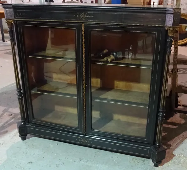 A Victorian gilt metal mounted parcel gilt ebonised side cabinet with pair of glazed doors flanked by fluted columns, 122cm wide x 106cm high x 39cm d