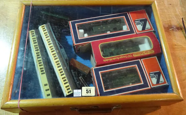 A group of nine Hornby trains and carriages within a 20th century mahogany and glass display box.